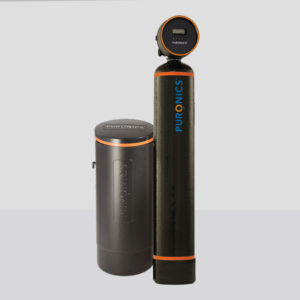 Whole property water softener system featuring a tall black tank and a cylindrical gray salt container, designed to remove limescale and enhance water quality for residential and commercial use.