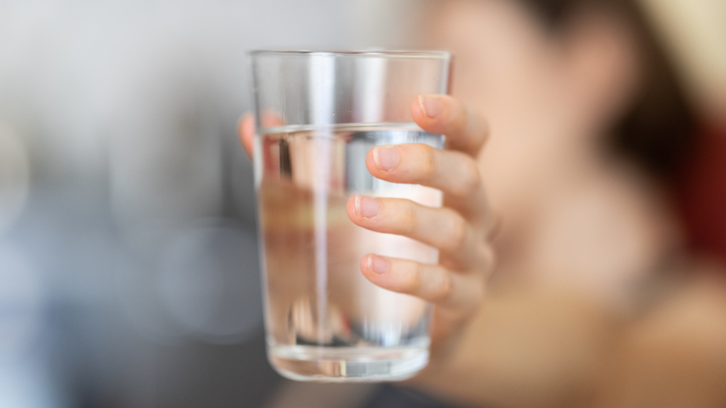 holding a glass of water